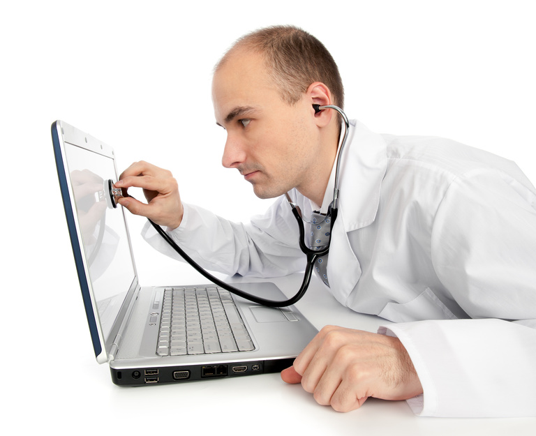 Doctor with stethoscope fixing laptop